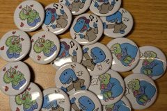 dinoheaded-girls-buttons-scaled-e1763568796307
